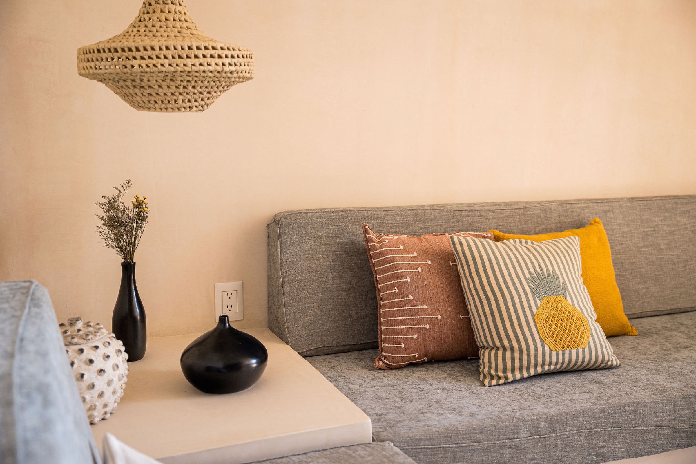Wonder Loft living room detail with woven pendant lamp and cushions