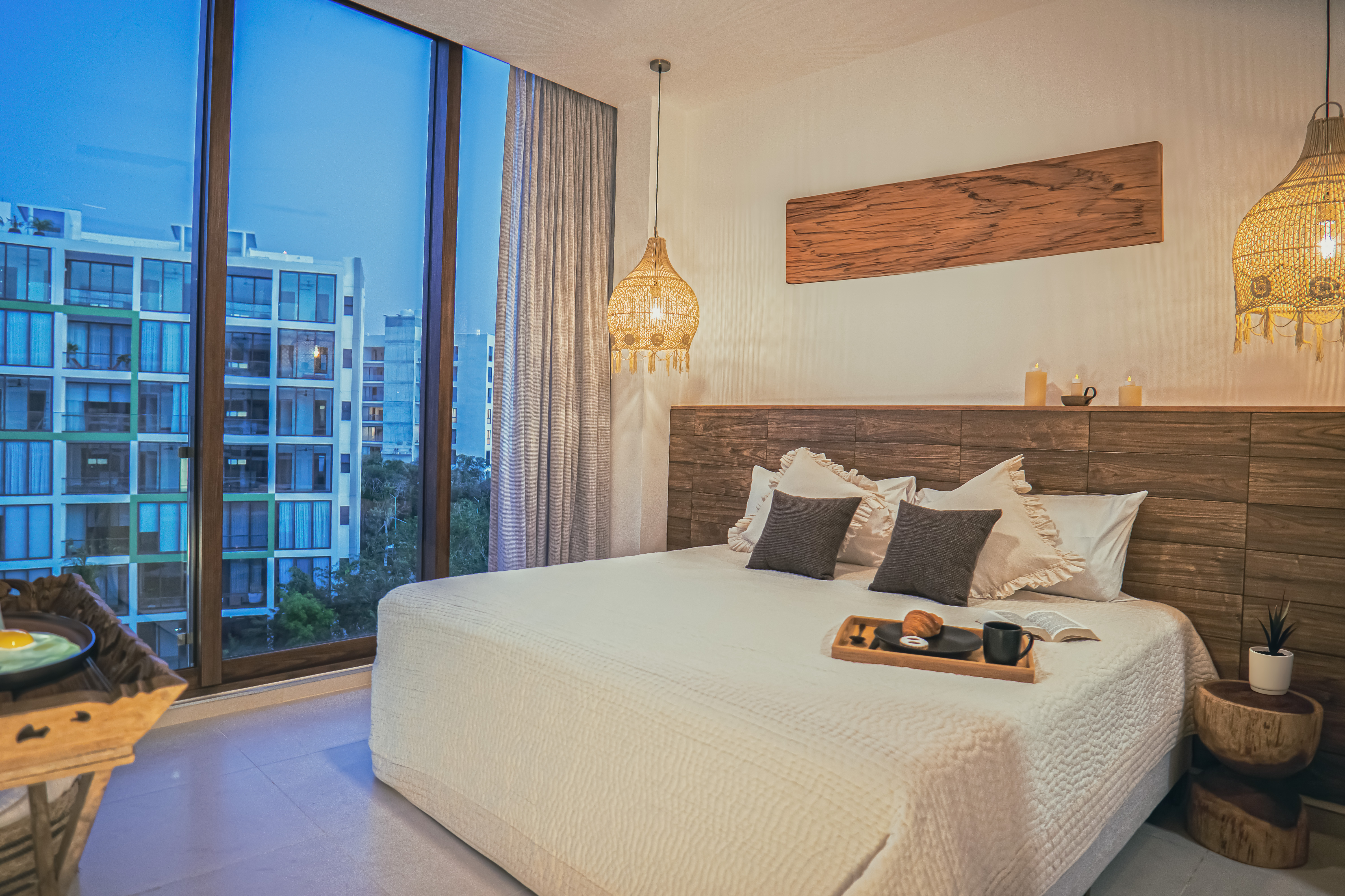 Bedroom at Bosques Roble with a view over neighboring Ciudad Mayakoba buildings