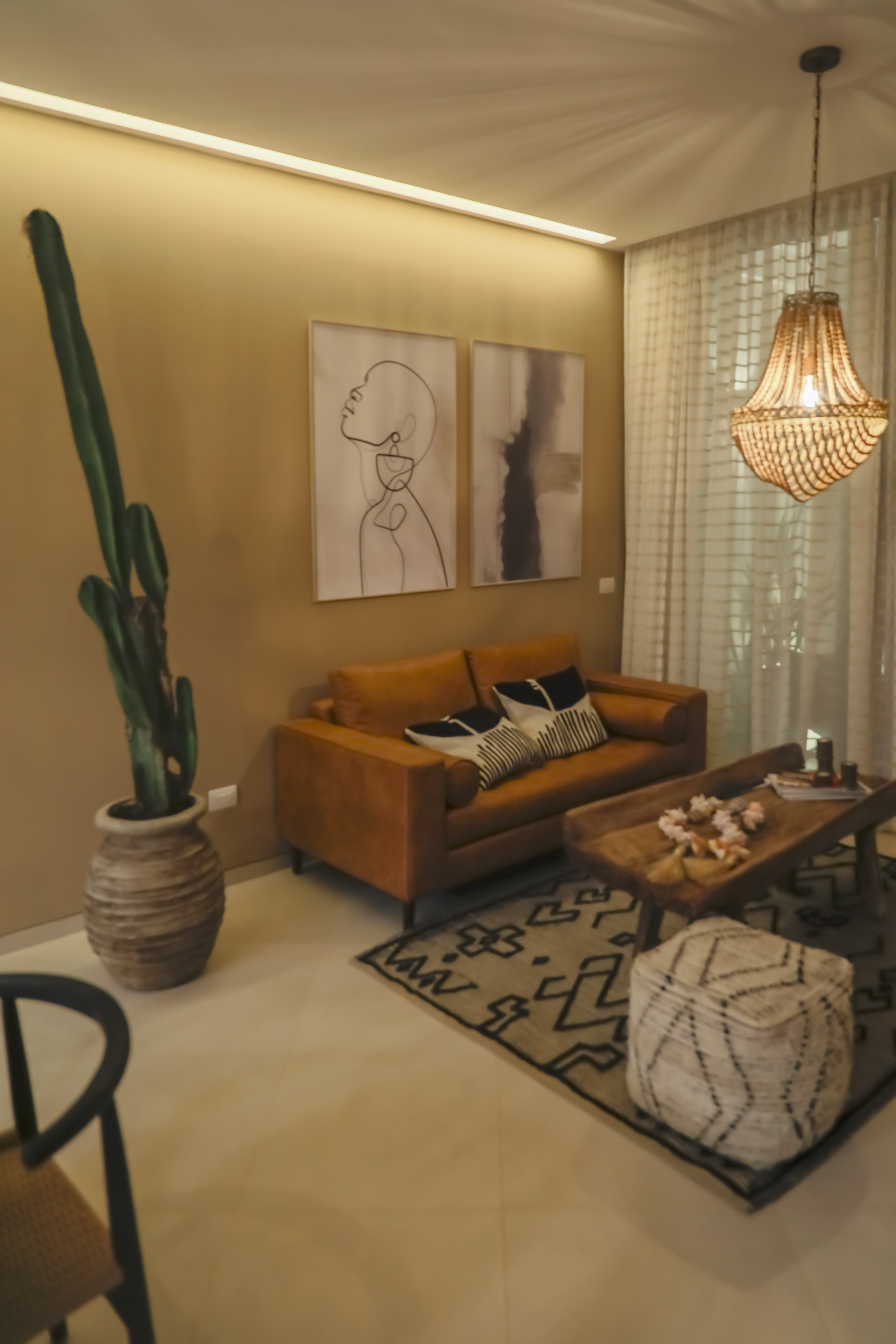 Lounge corner with a cactus and framed prints at Bosques Roble