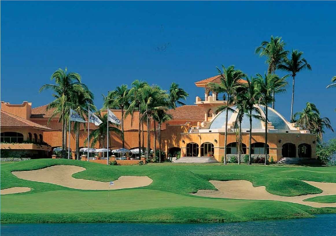Golf clubhouse beyond a bunkered green
