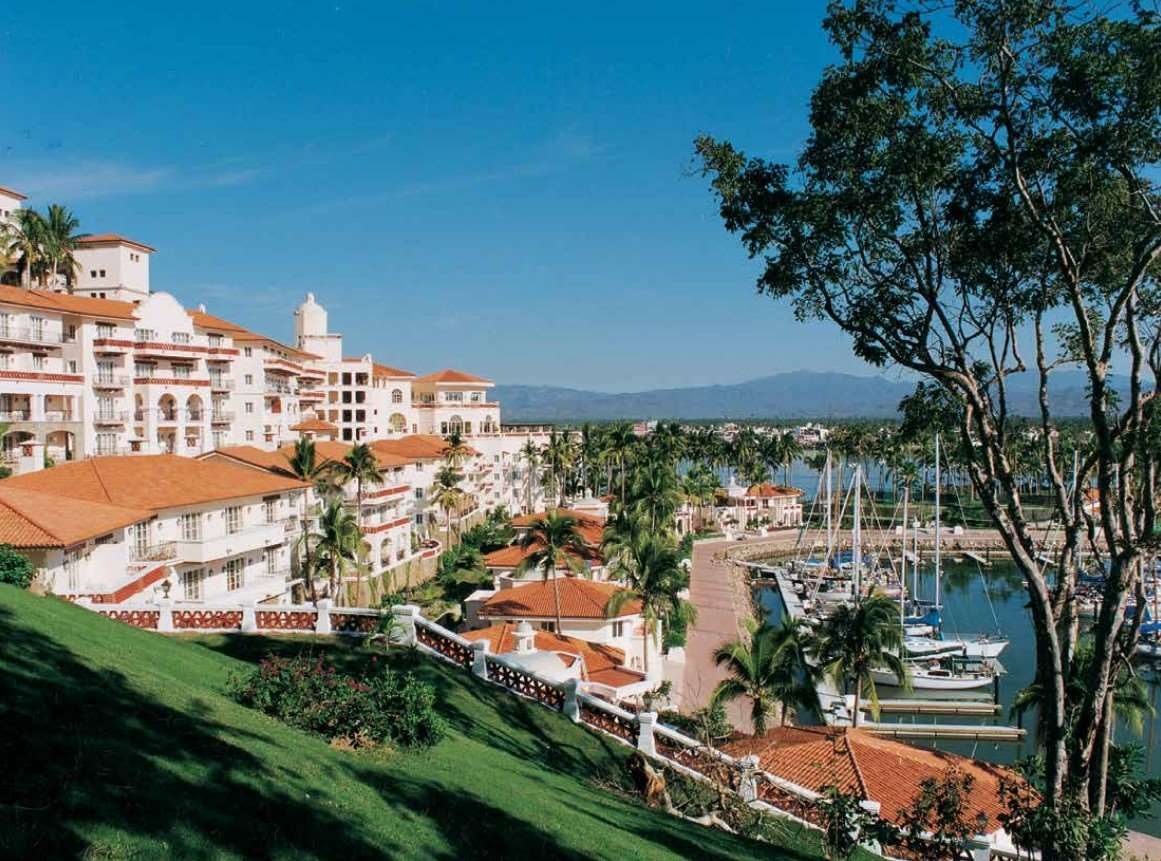 Hotel buildings stepping down the hillside to the marina