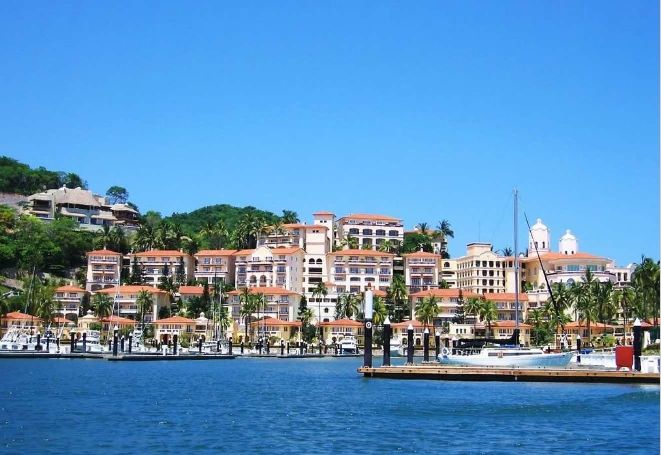 Marina waterfront with boats and the hotel behind
