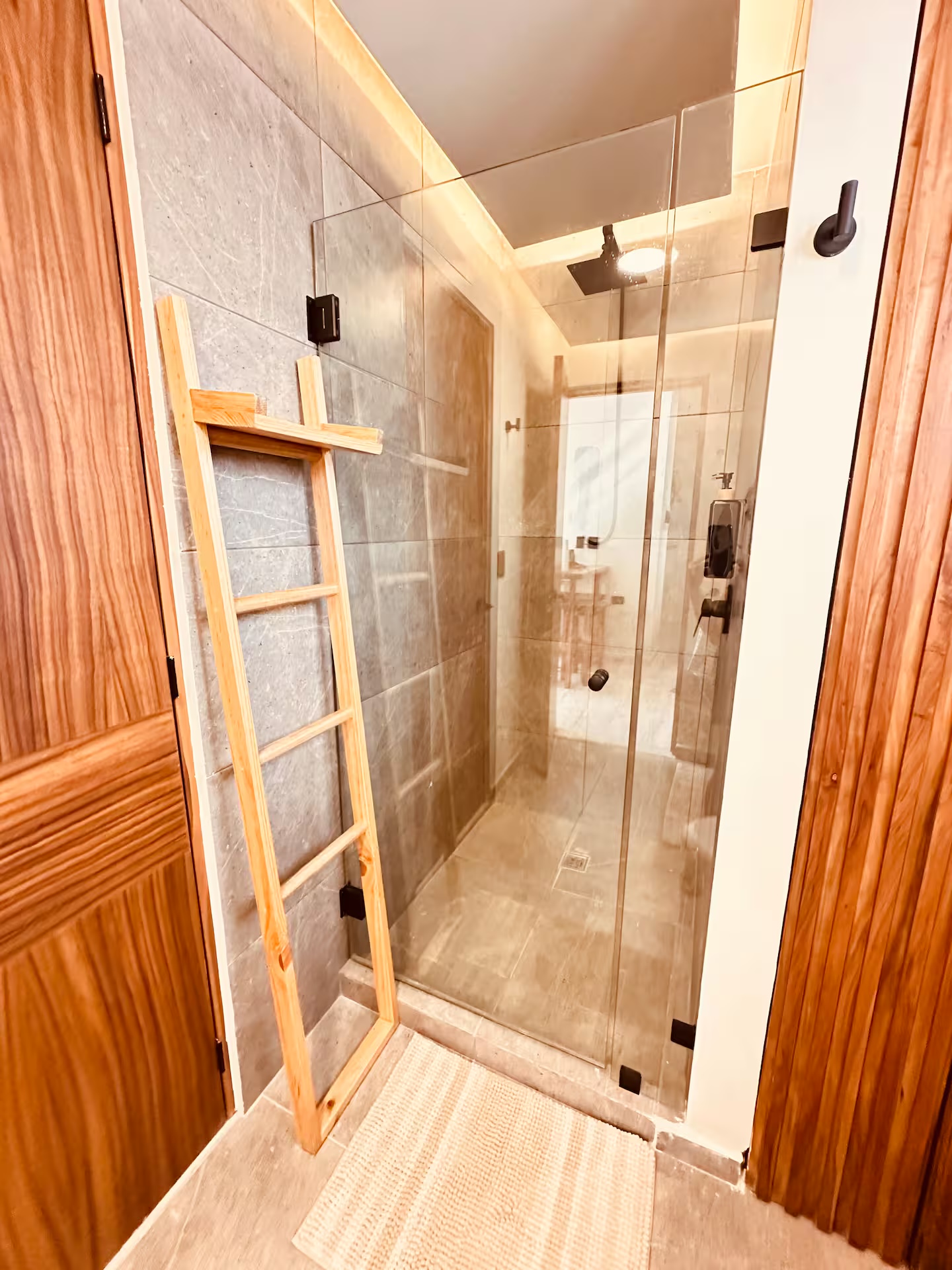 Bathroom of unit F303 with glass-enclosed shower