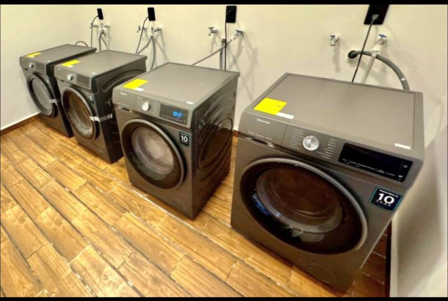 Shared laundry room at Naia Naay Village with four washing machines