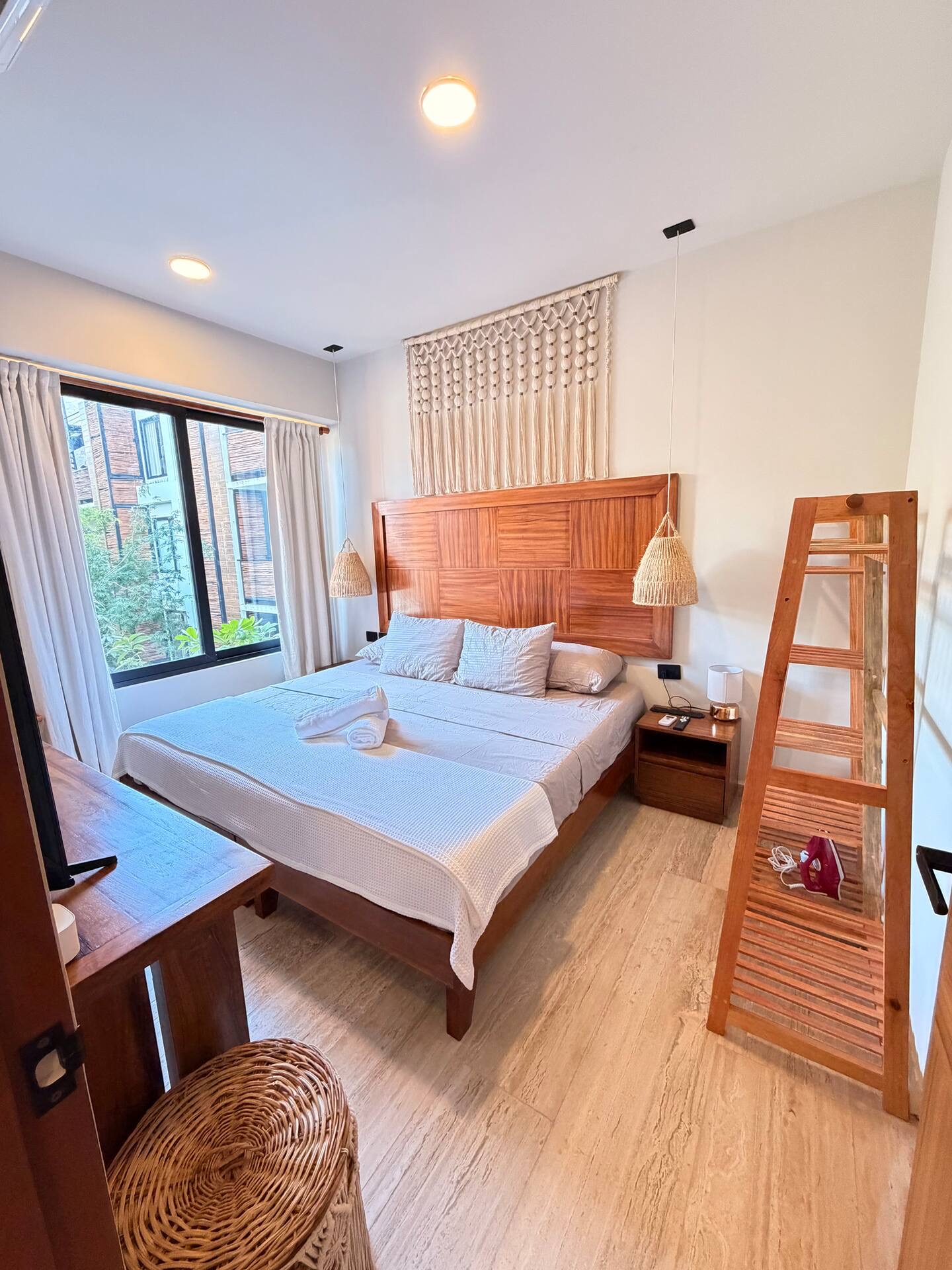 Primary bedroom of unit F303 with a queen bed