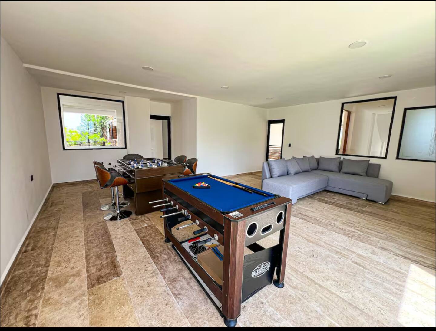 Games room with foosball and pool table at Naia Naay Village