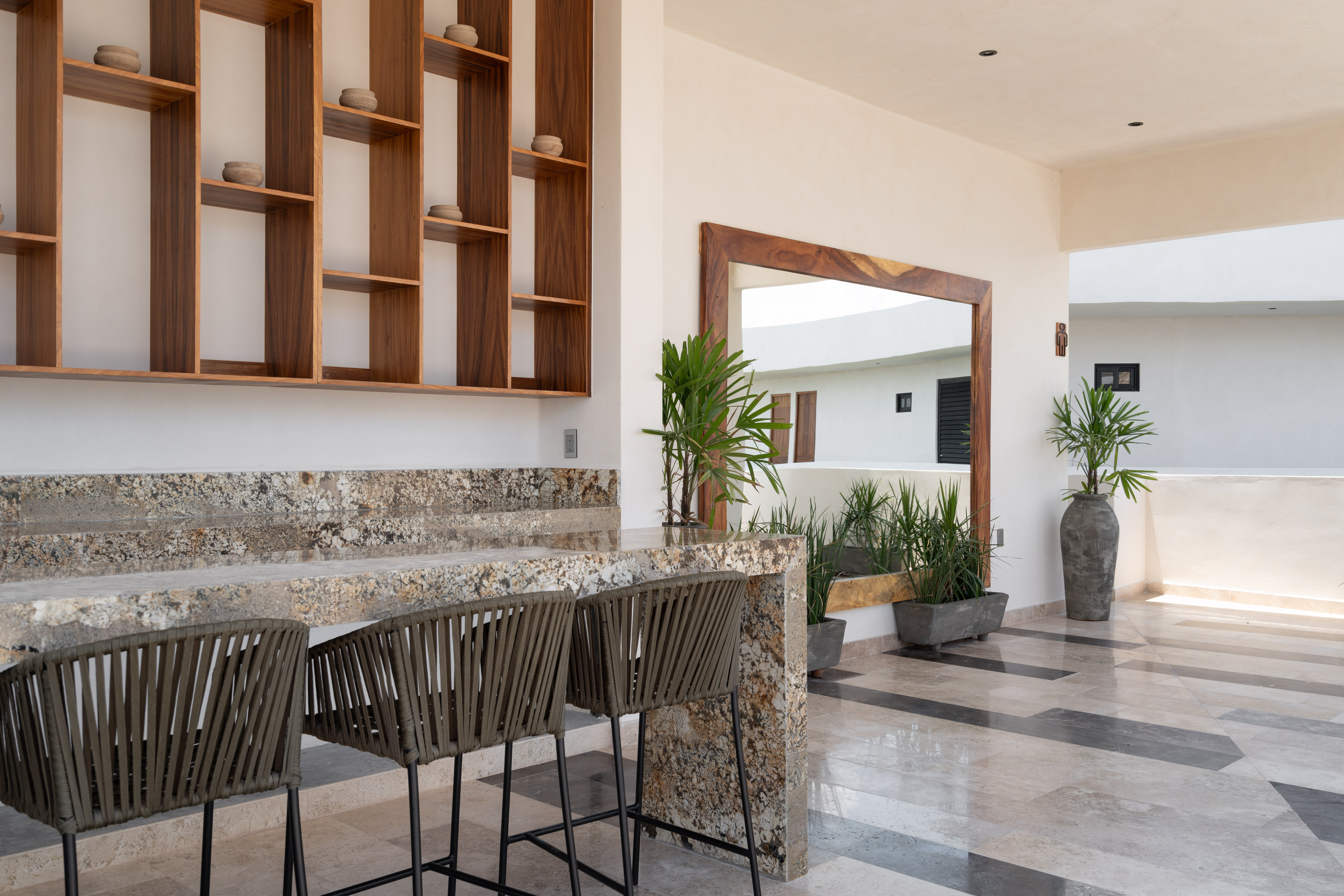 Rooftop bar detail with wood shelving and stone counter
