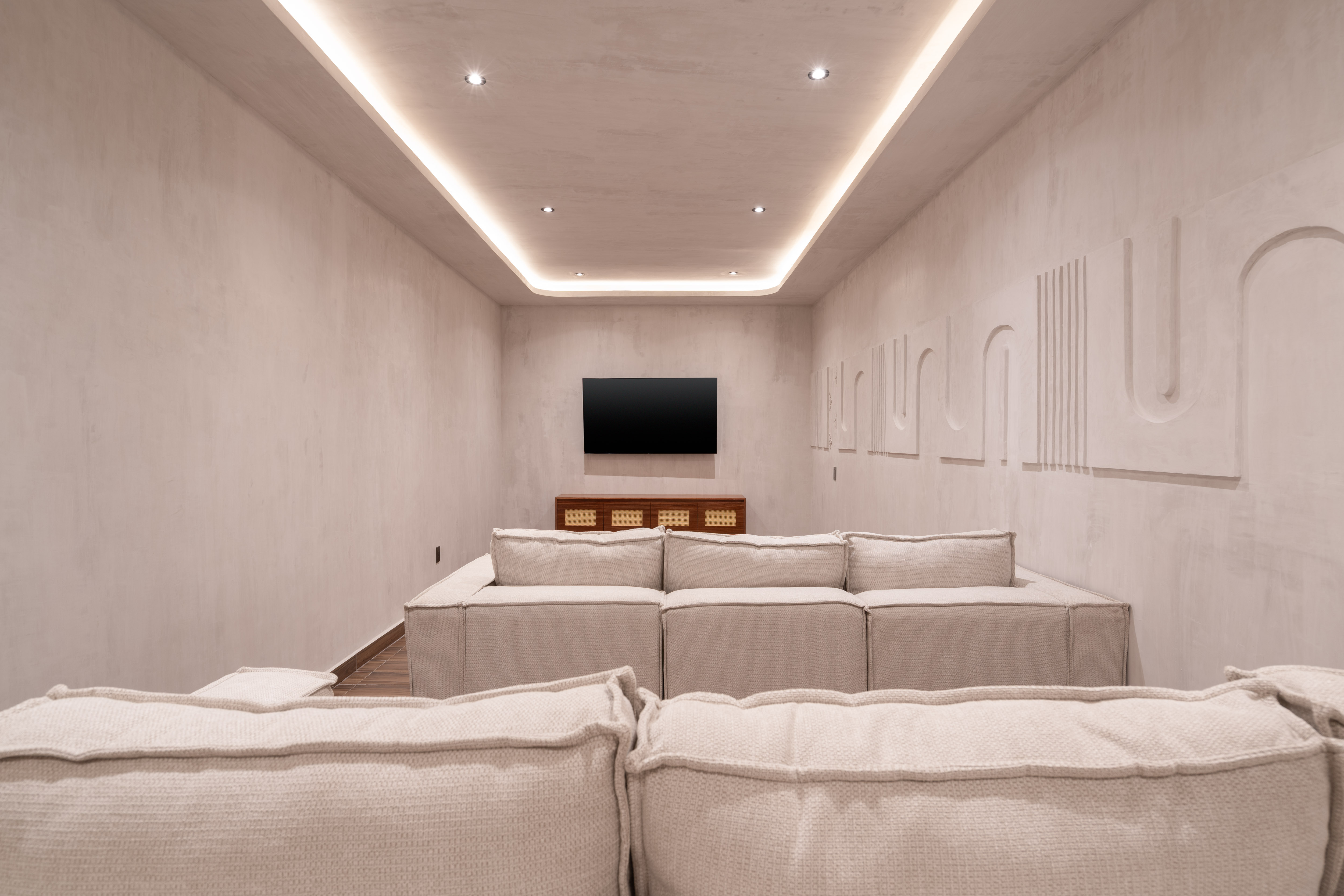 Private cinema room with sculpted plaster walls