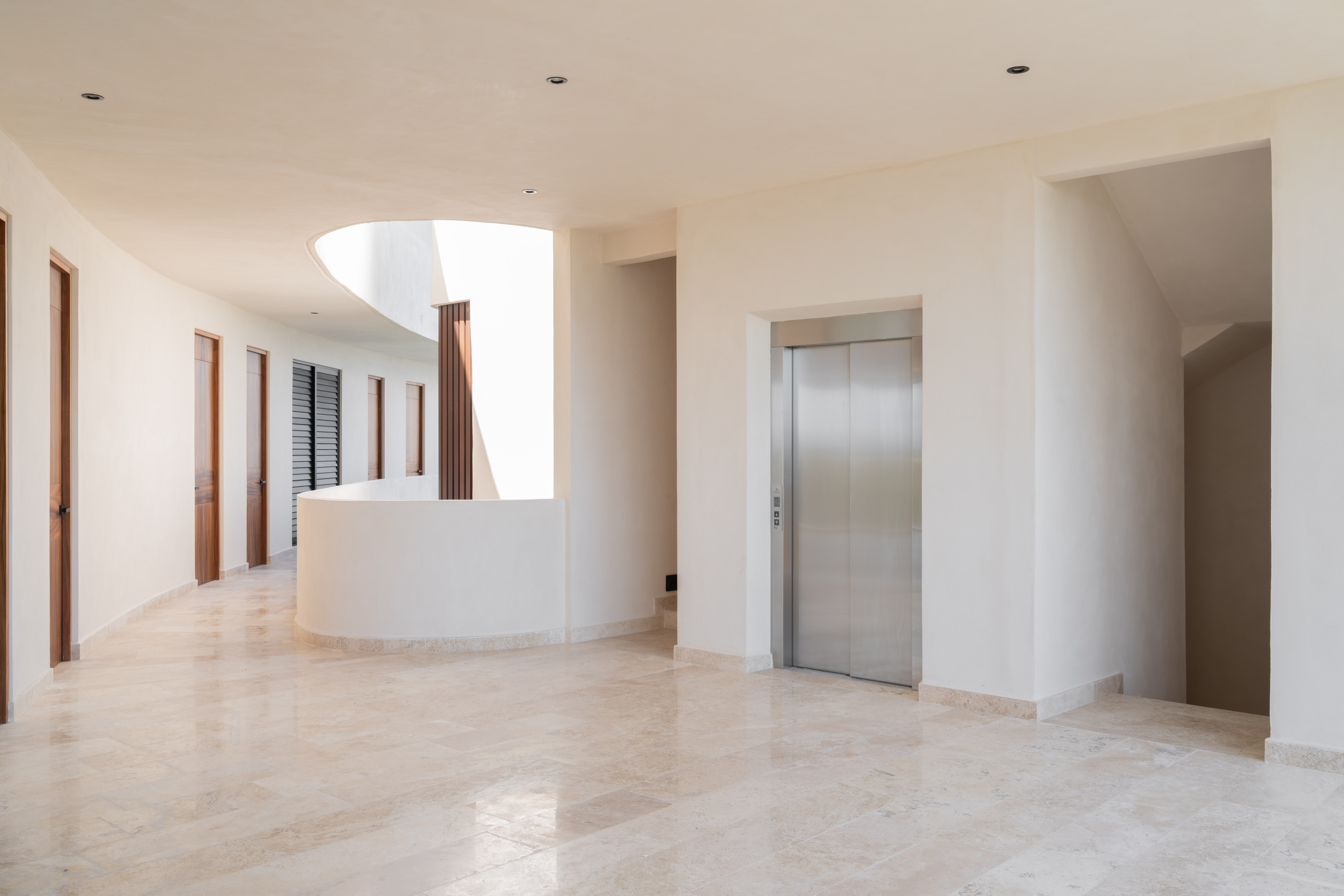 Curved ground-floor corridor and elevator lobby