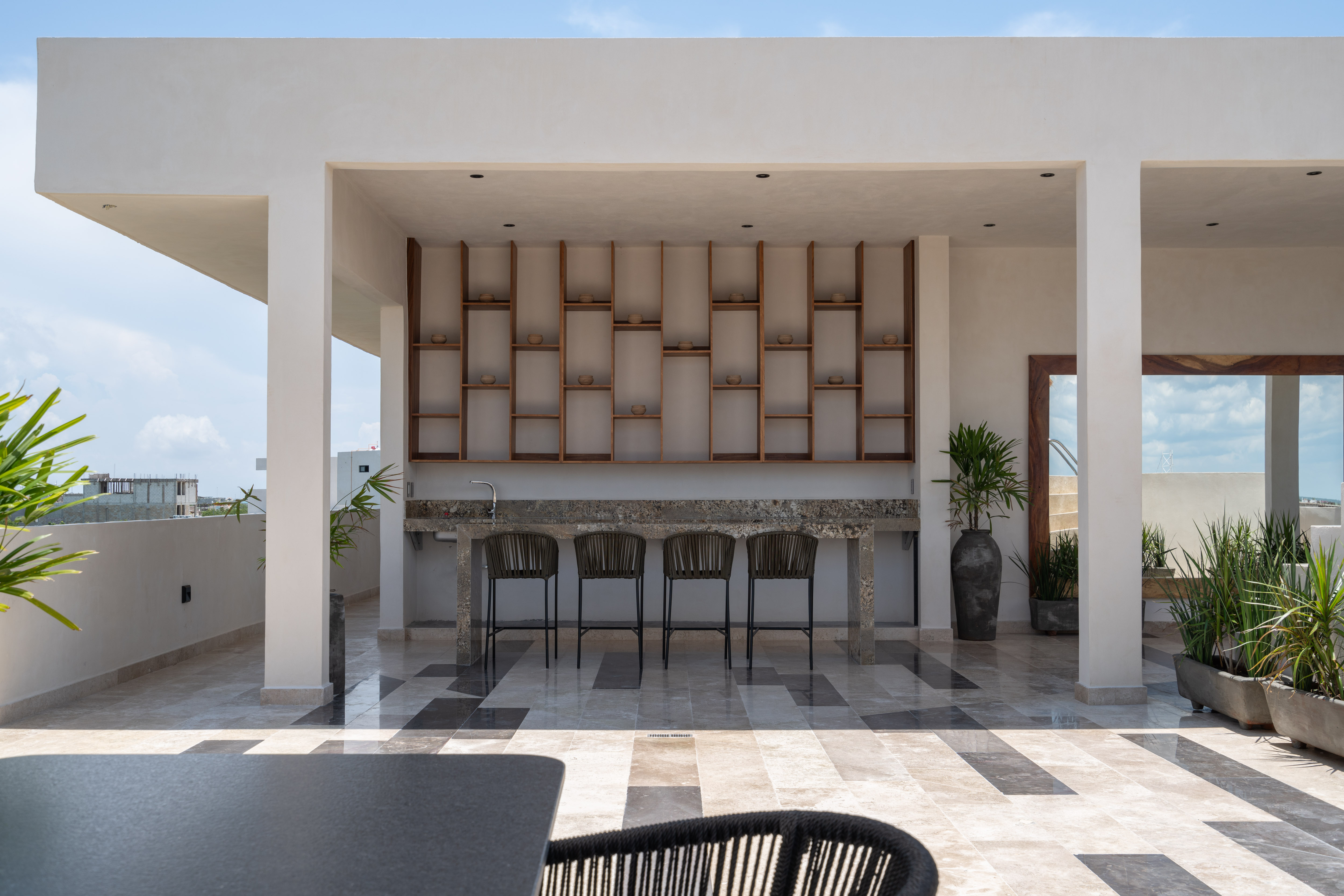 Rooftop bar with wood shelving at Narai