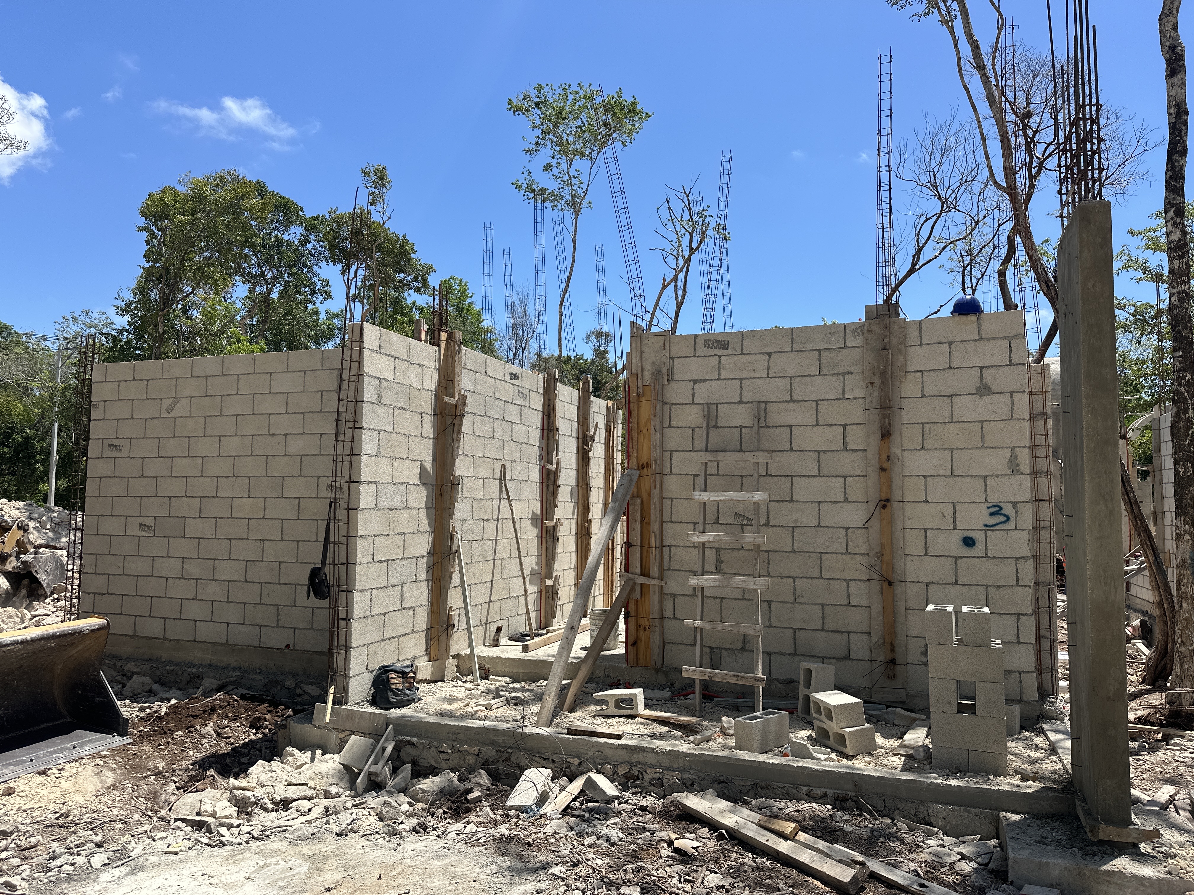Cinder-block walls under construction at Nonai Villas, April 2026
