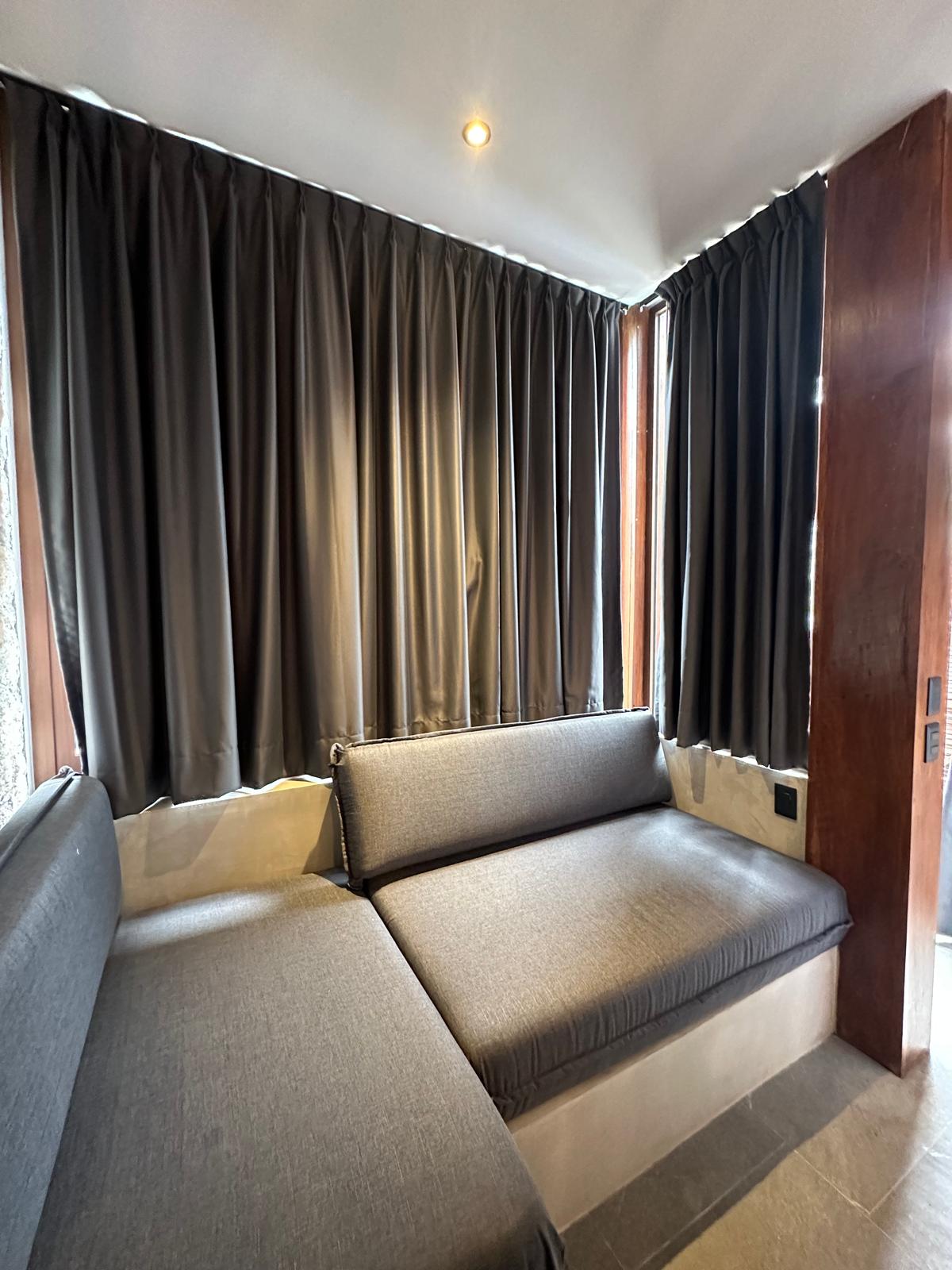 A second seating nook inside B2-101, wood-ceilinged, opening onto the terrace