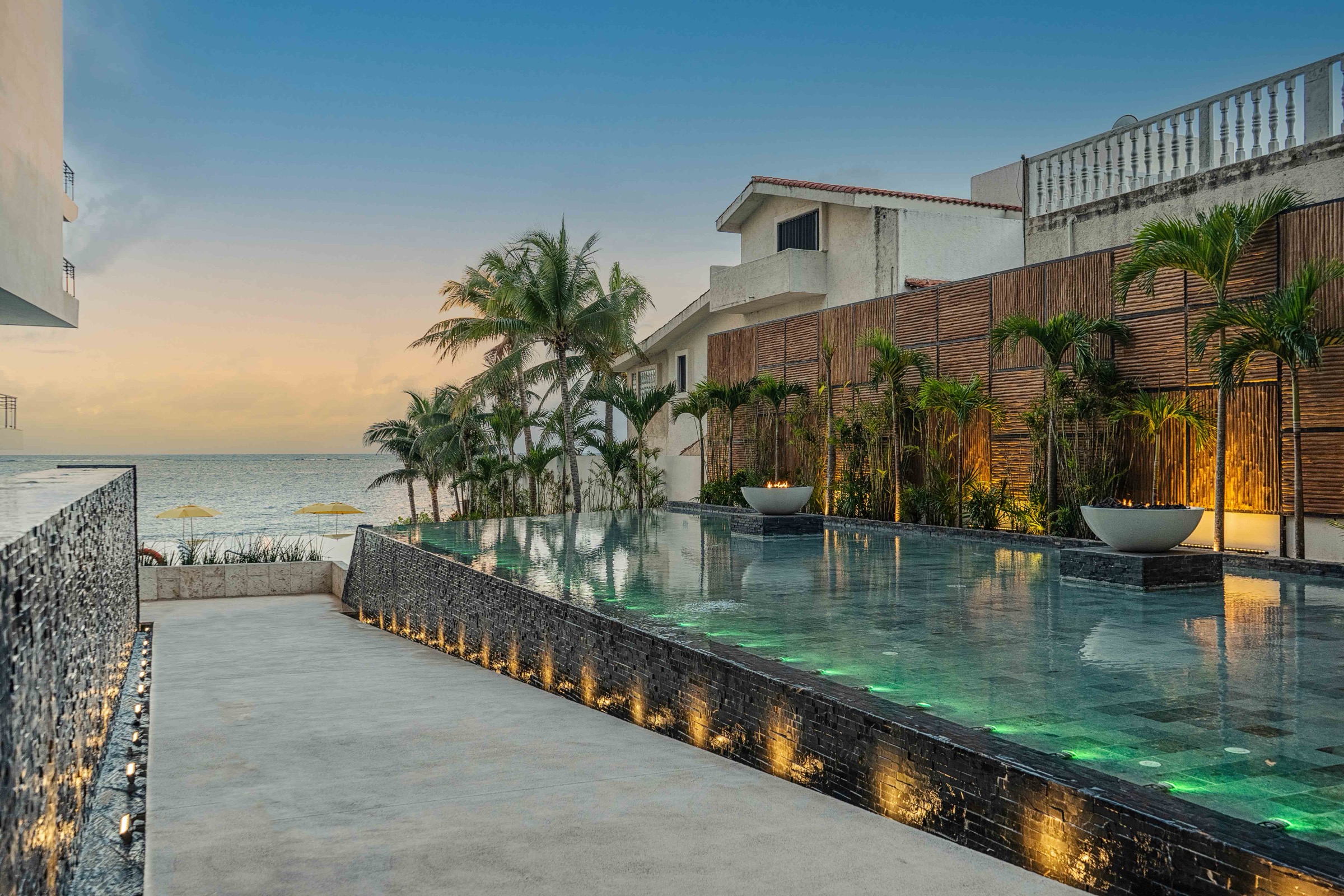 Infinity pool deck at dusk at The Fives Oceanfront