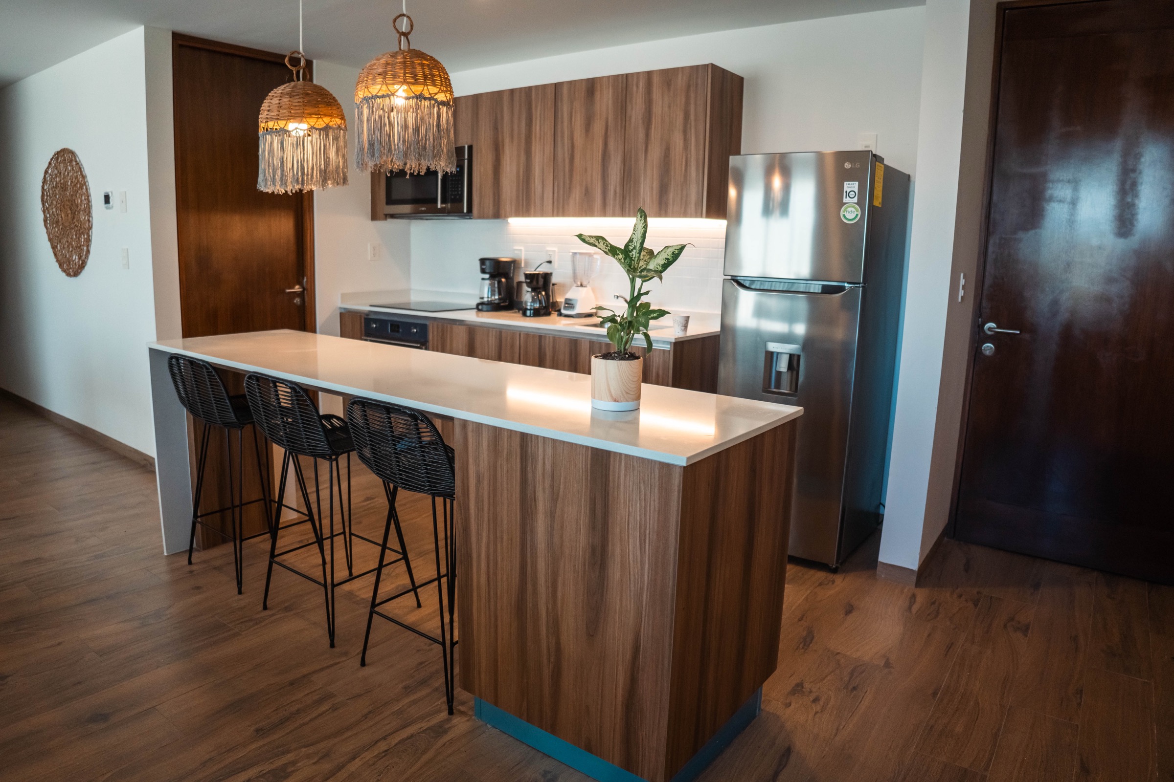 Kitchen and breakfast bar in the three-bedroom model unit at The Leaf Condos Playacar