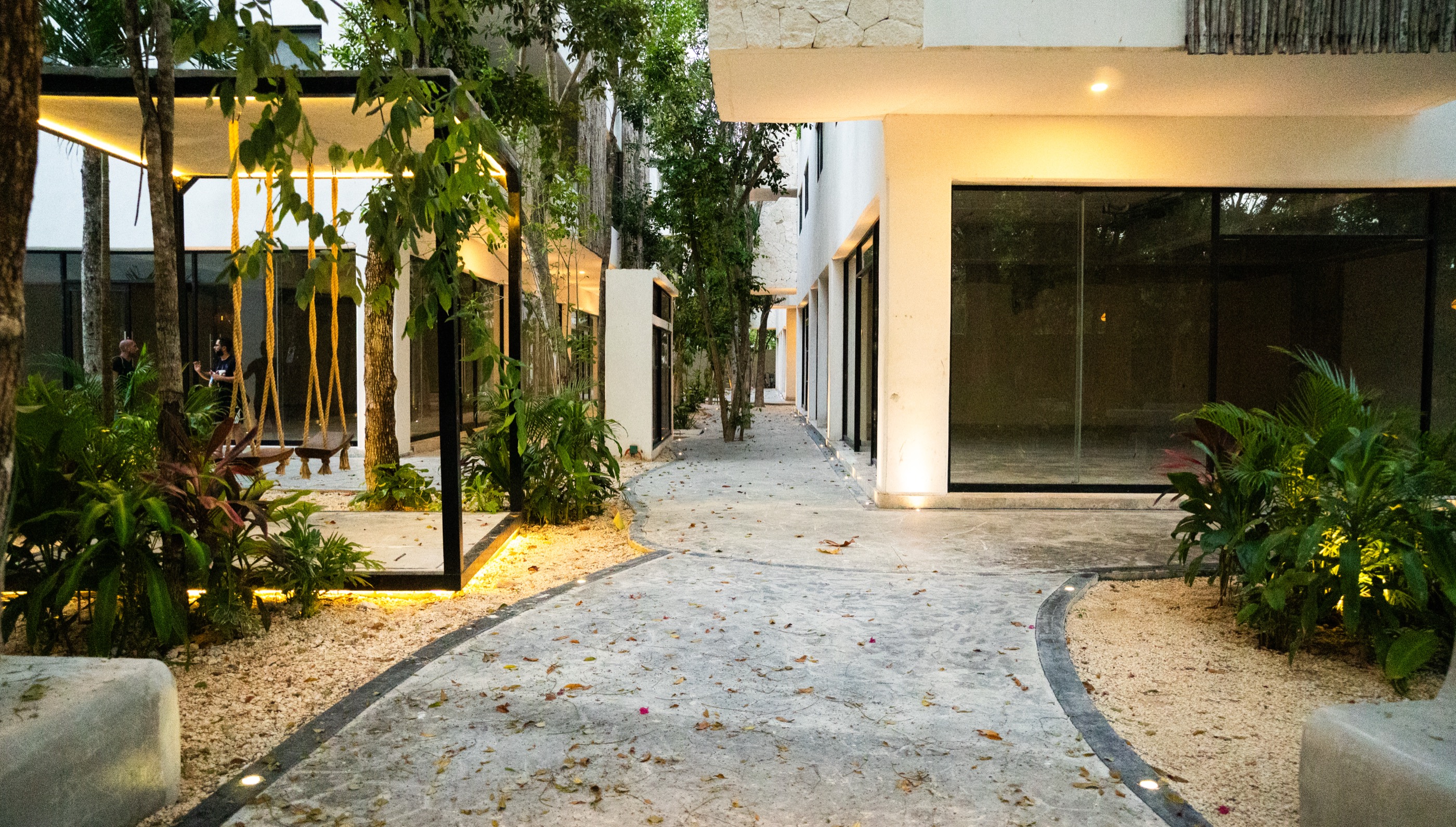 The ground-floor commercial corridor at Town Center Zamá, glazed and lit, with no tenants