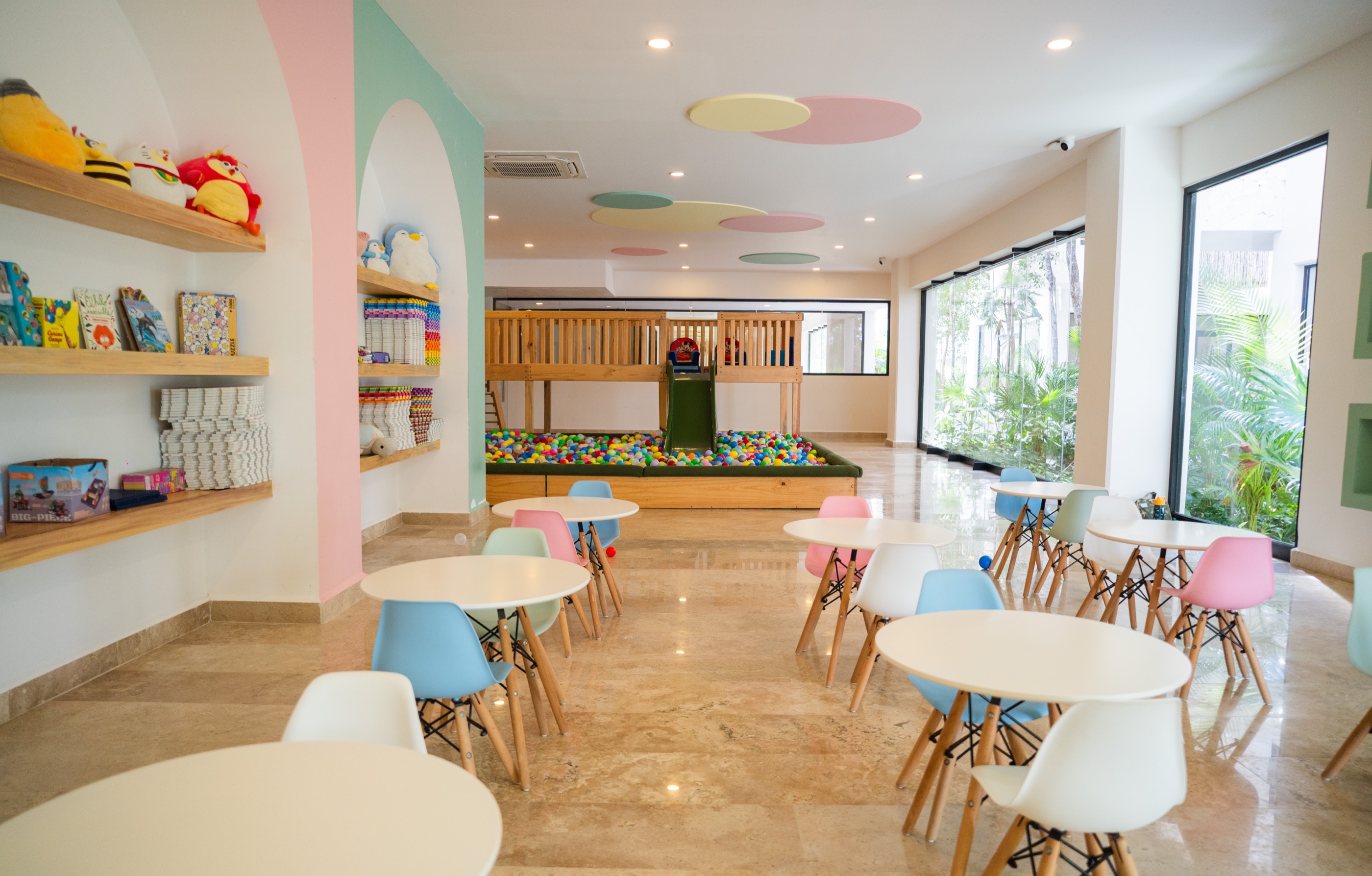 Children’s playroom with pastel furniture and a library wall