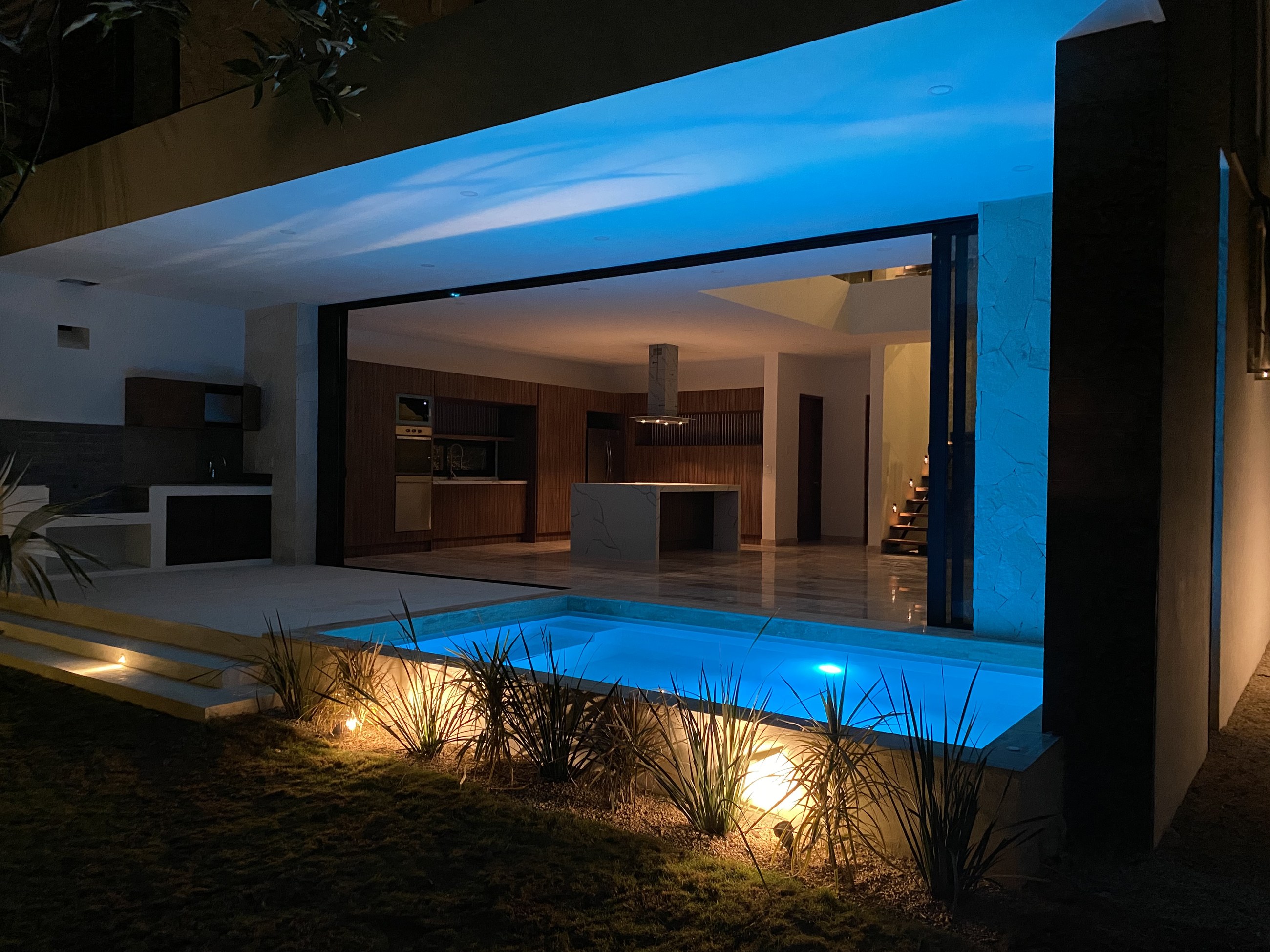 Kitchen and pool at night, finished Villa Tortuga, Villas Aliada