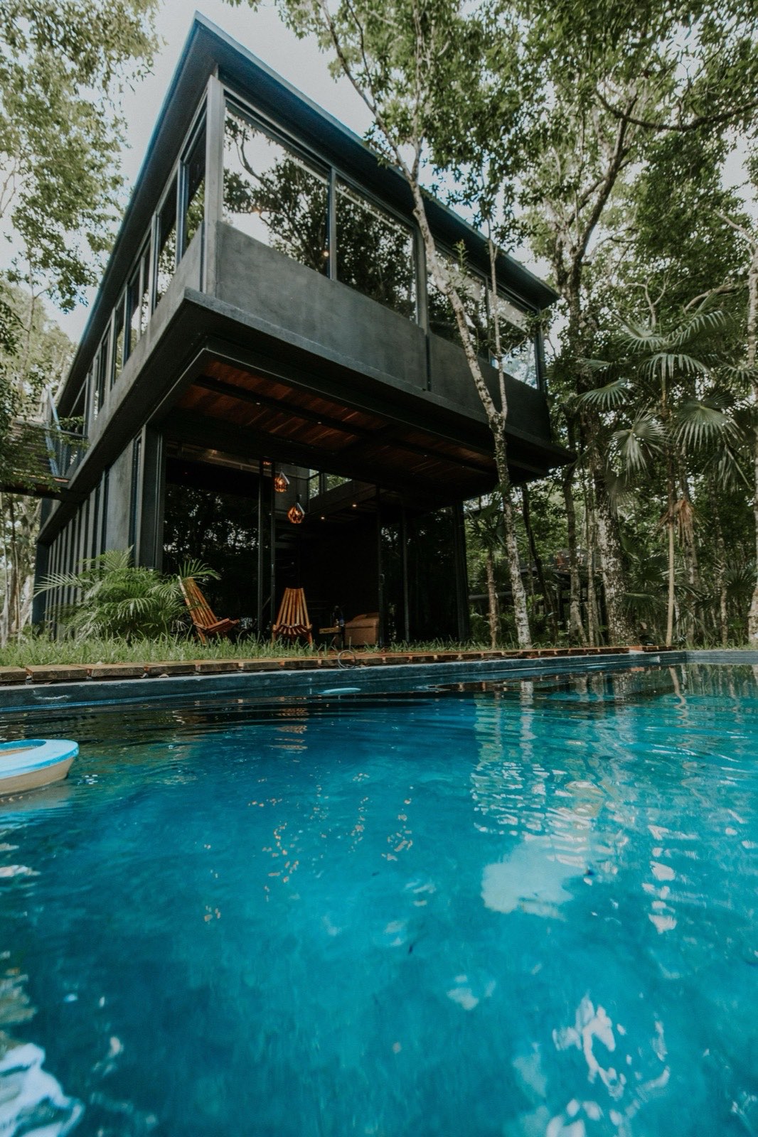 Black glass volume over a pool deep in the jungle