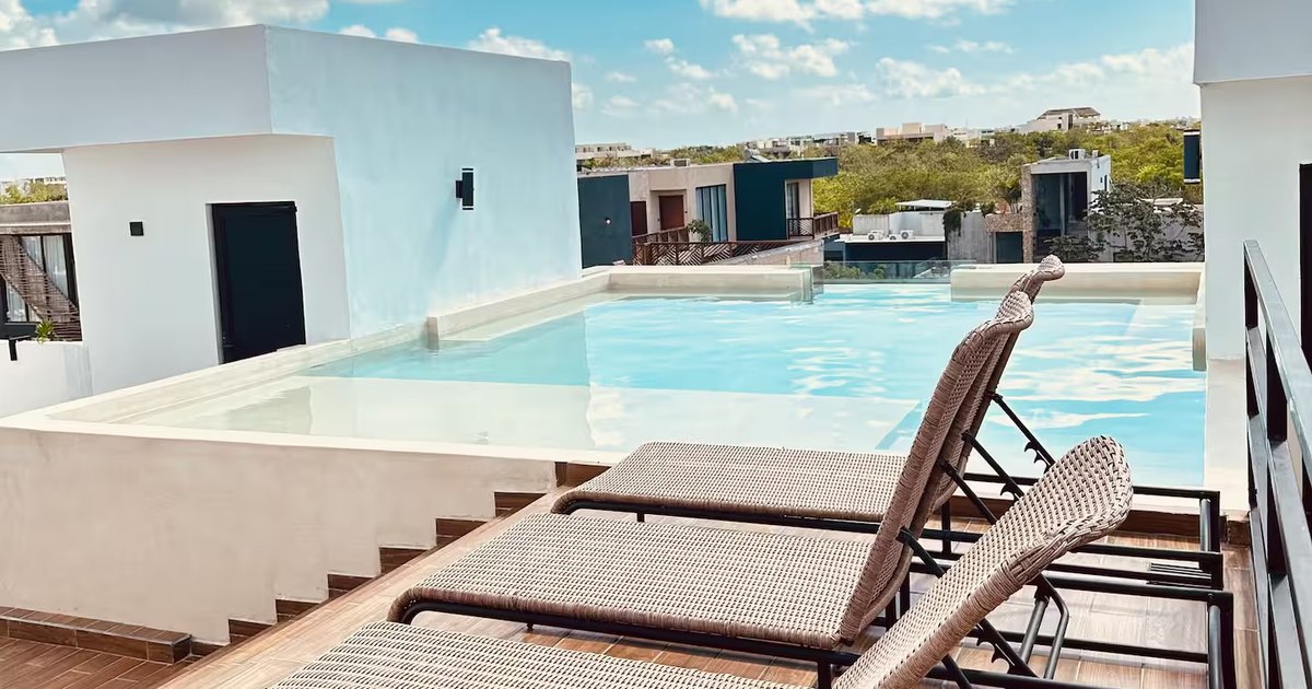 Rooftop gym at Naia Naay Village, Región 15, Tulum, overlooking the jungle canopy