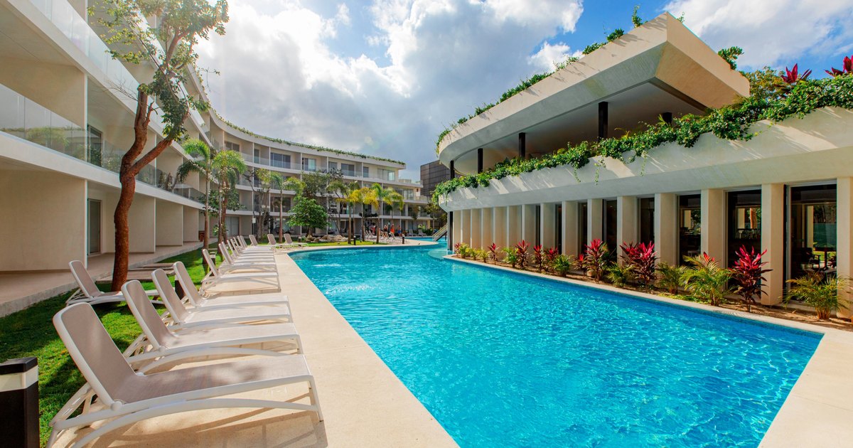 Lap pool and planted terraces between two finished residential wings at The Leaf Condos Playacar, Playa del Carmen